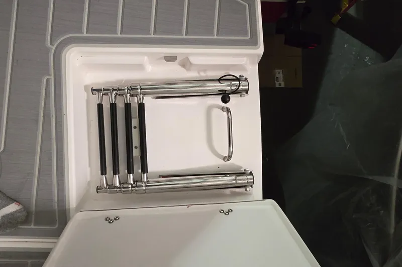 Slide: The Image of 2024 Regal 42 Fly yacht helm with steering wheel and control panel in a marina. - 25