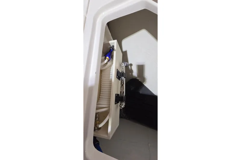 Slide: The Image of 2024 Regal 42 Fly yacht interior with modern helm and seating in a dimly lit showroom. - 29