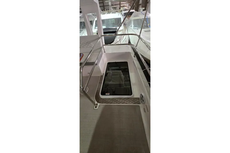 Slide: The Image of 2024 Regal 42 Fly yacht interior with seating and table in a storage facility. - 32