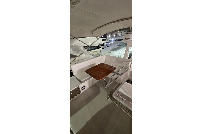 Slide: The Image of 2024 Regal 42 Fly yacht interior with Garmin equipment and elegant seating area. - 33