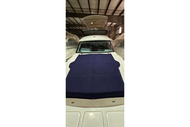 Slide: The Image of 2024 Regal 42 Fly yacht docked, featuring "You're so Vein" text on the stern. - 4