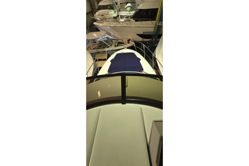 Slide: The Image of 2024 Regal 42 Fly yacht interior with bed, wooden doors, and stairs. - 43