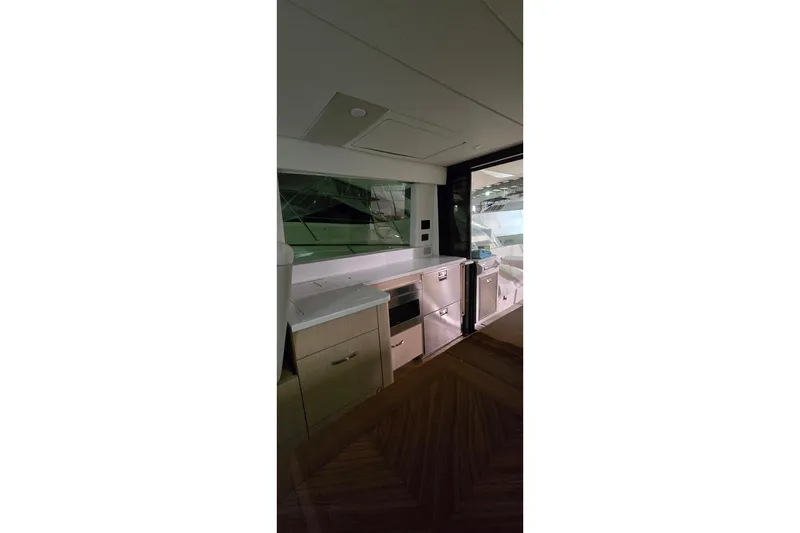 Slide: The Image of Wooden closet with folded linens inside the 2024 Regal 42 Fly yacht. - 57