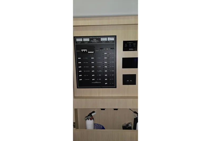 Slide: The Image of Electrical control panel of 2024 Regal 42 Fly yacht, featuring various switches and indicators. - 59