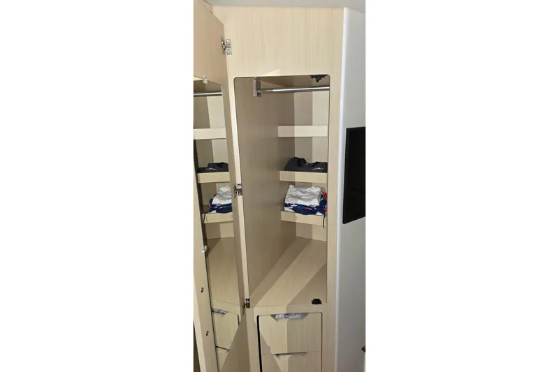 Slide: The Image of Luxurious interior of 2024 Regal 42 Fly yacht with white seating and striped cushions. - 66