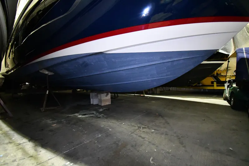 Slide: The Image of 2024 Regal 42 Fly yacht hull in storage, showcasing sleek design and vibrant colors. - 88