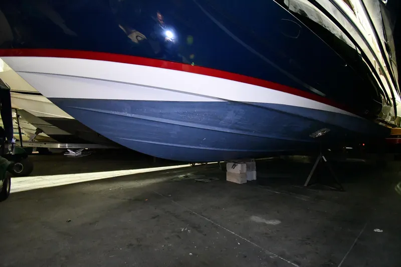 Slide: The Image of 2024 Regal 42 Fly yacht hull in dry dock, showcasing sleek design and vibrant colors. - 89