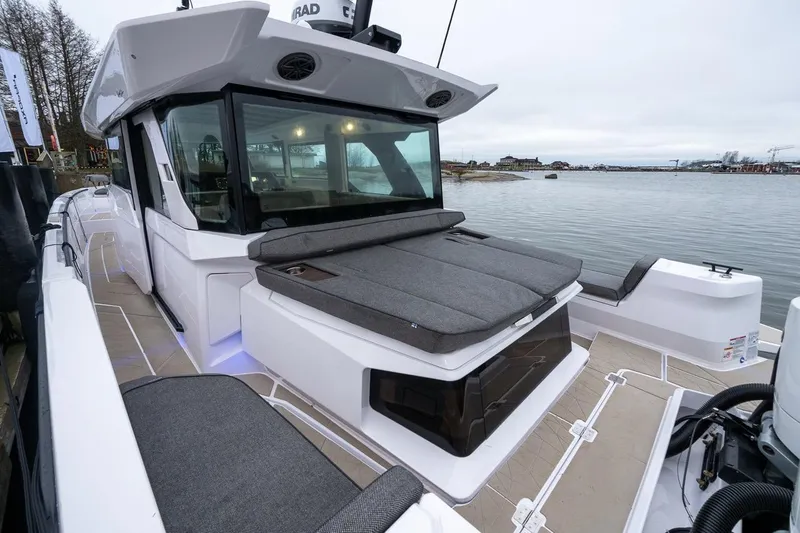 Slide: The Image of 2027 Axopar 38 Cross Cabin boat with sleek design and spacious deck by the water. - 10