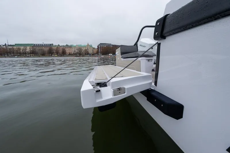 Slide: The Image of 2027 Axopar 38 Cross Cabin boat with extended platform on calm water. - 18