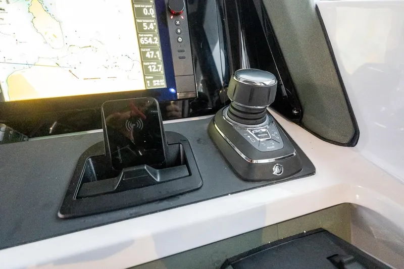 Slide: The Image of Control panel of 2027 Axopar 38 Cross Cabin with navigation display and joystick. - 39