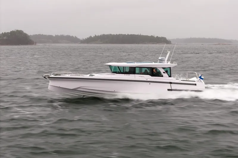 Slide: The Image of 2027 Axopar 38 Cross Cabin boat cruising on a cloudy day. - 4