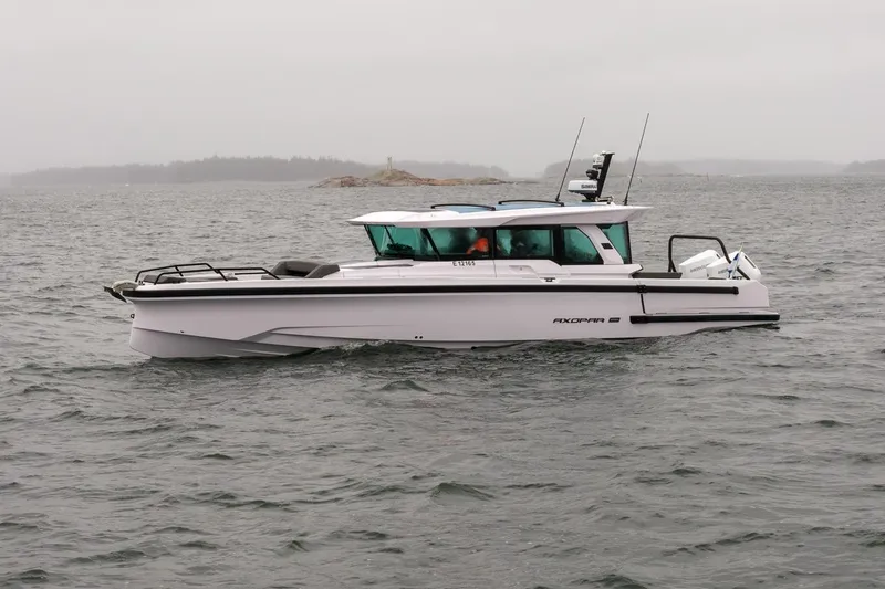 Slide: The Image of 2027 Axopar 38 Cross Cabin boat cruising on a cloudy day. - 5