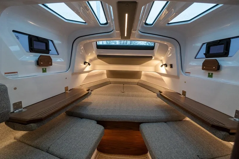 Slide: The Image of Luxurious interior of 2027 Axopar 38 Cross Cabin with modern seating and ambient lighting. - 50