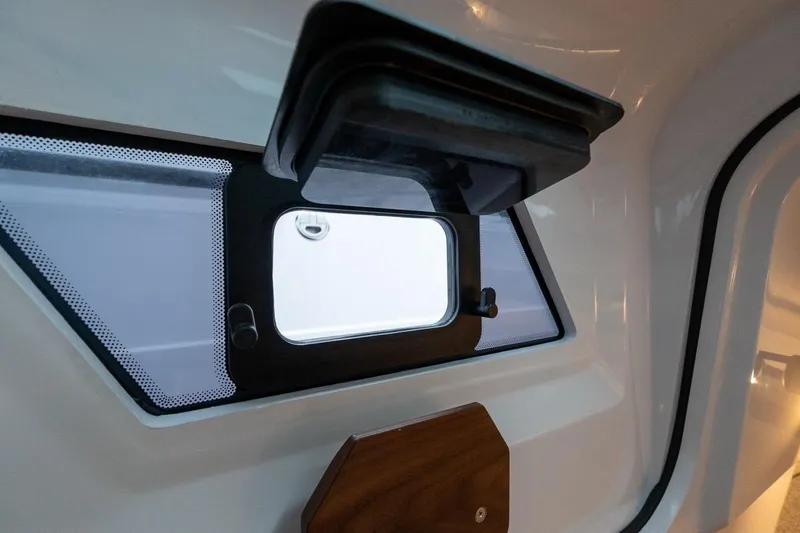 Slide: The Image of 2027 Axopar 38 Cross Cabin interior window detail with open hatch. - 51