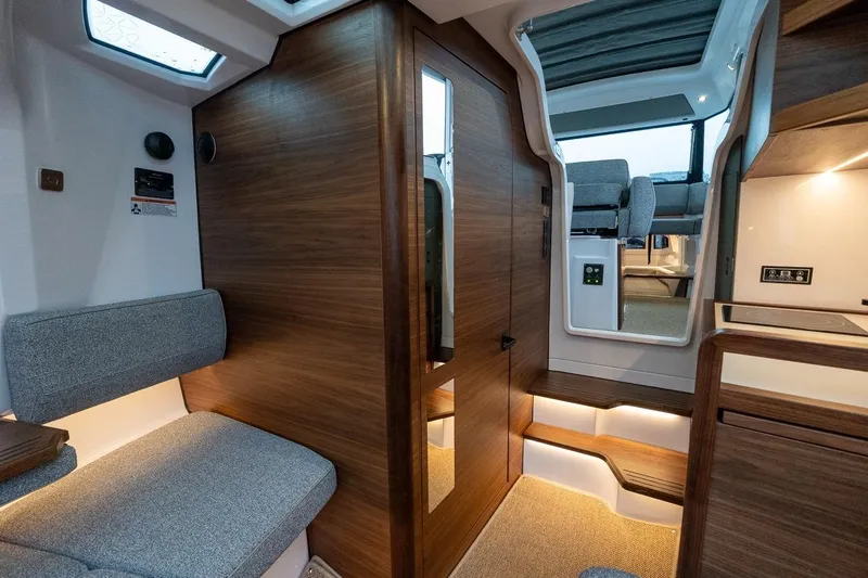 Slide: The Image of Interior of 2027 Axopar 38 Cross Cabin, featuring modern wood and gray upholstery. - 53
