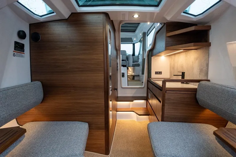 Slide: The Image of Luxurious interior of 2027 Axopar 38 Cross Cabin with modern wood finishes and seating. - 54