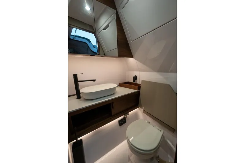 Slide: The Image of Modern bathroom interior of 2027 Axopar 38 Cross Cabin boat, featuring sleek sink and toilet. - 56
