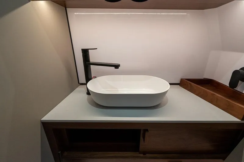 Slide: The Image of Modern bathroom sink in 2027 Axopar 38 Cross Cabin boat interior. - 57