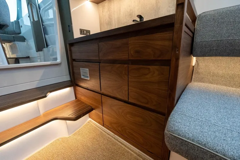 Slide: The Image of Luxurious interior of 2027 Axopar 38 Cross Cabin with wooden cabinetry and modern seating. - 59