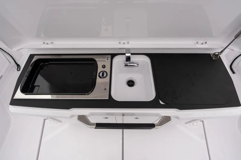 Slide: The Image of 2027 Axopar 38 Cross Cabin kitchenette with sink and stove. - 67