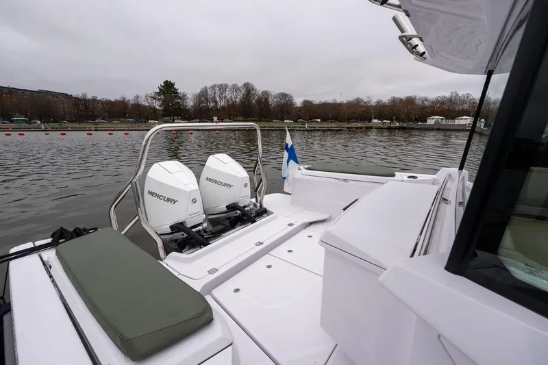 Slide: The Image of 2027 Axopar 38 Cross Cabin with dual Mercury engines on a calm lake. - 70