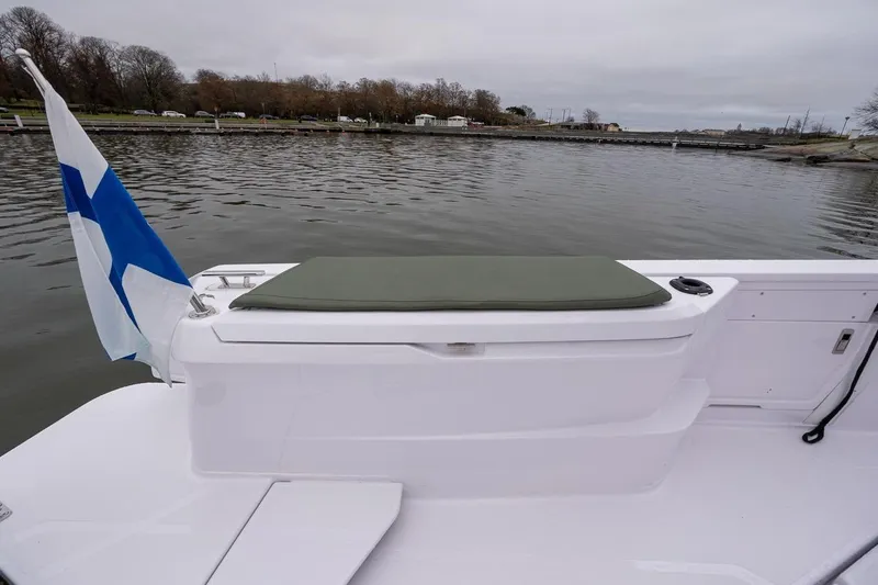 Slide: The Image of 2027 Axopar 38 Cross Cabin boat with Finnish flag on calm water. - 73