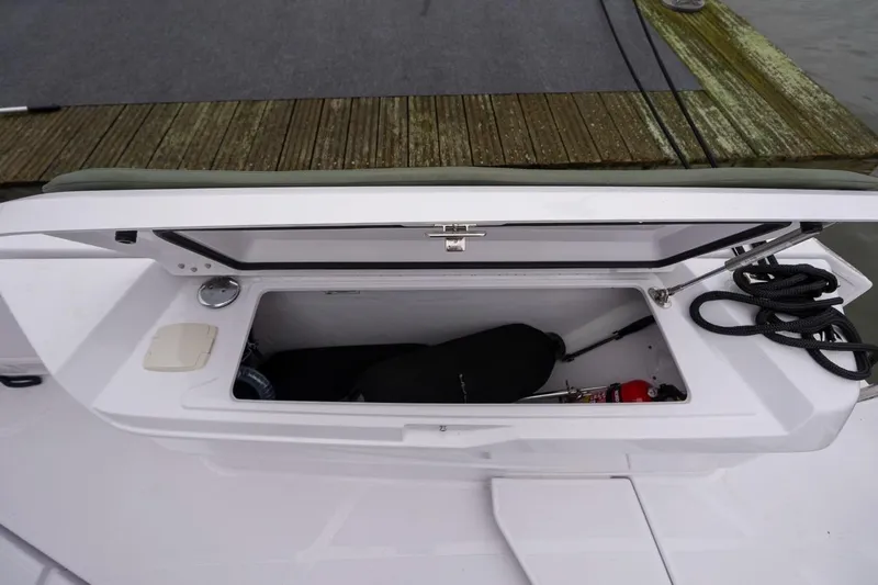 Slide: The Image of Storage compartment on 2027 Axopar 38 Cross Cabin boat, featuring ropes and equipment. - 76