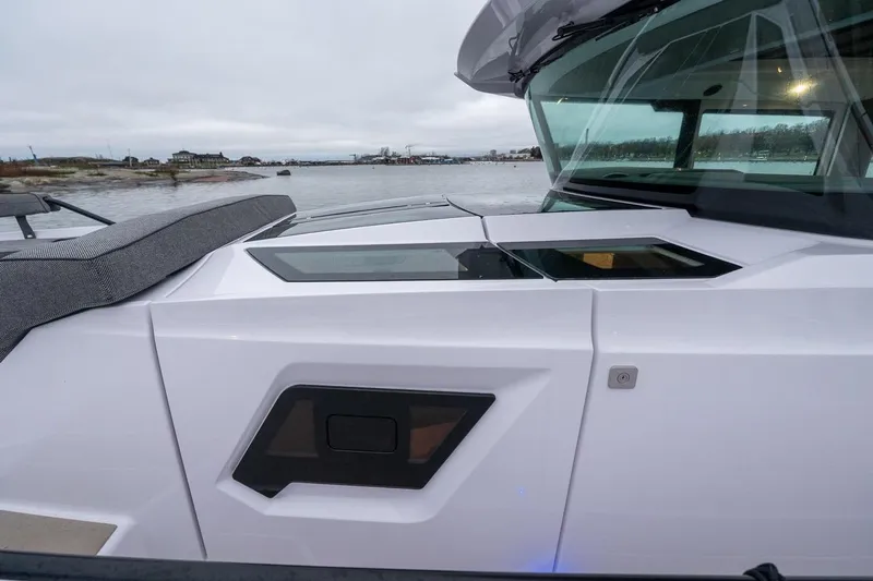 Slide: The Image of 2027 Axopar 38 Cross Cabin boat on calm water, showcasing sleek design and modern features. - 9