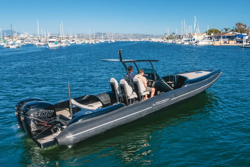 Slide: The Image of 2019 Technohull Sea DNA 999 boat cruising in a marina with two passengers. - 12