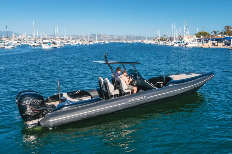 Slide: The Image of 2019 Technohull Sea DNA 999 boat cruising in a marina with clear blue water. - 13