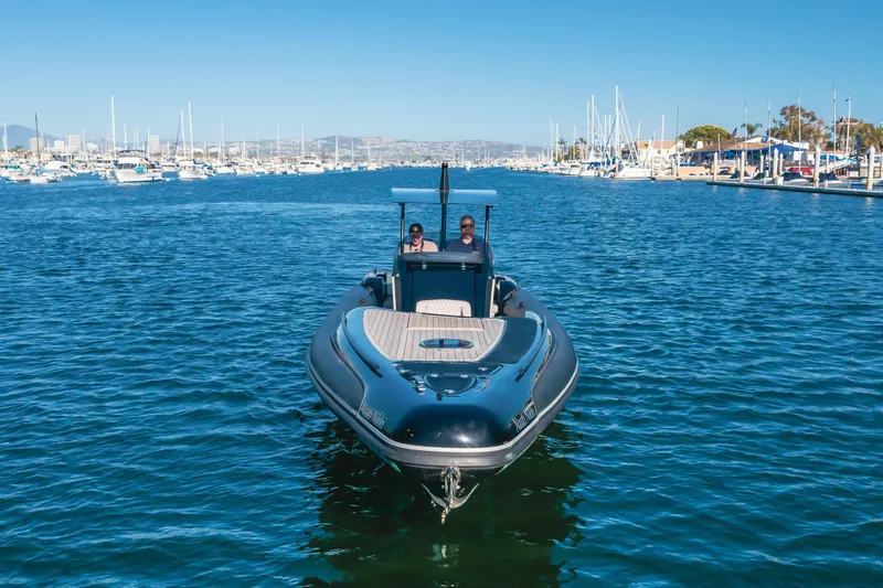 Slide: The Image of 2019 Technohull sea DNA 999 boat cruising in a marina with clear blue skies. - 14