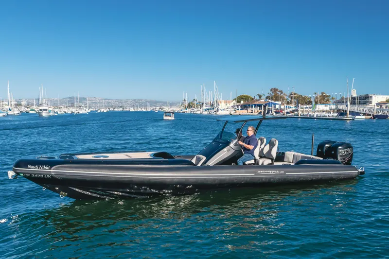 Slide: The Image of 2019 Technohull sea DNA 999 boat cruising in a marina under clear blue skies. - 15
