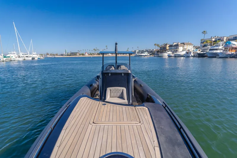 Slide: The Image of 2019 Technohull sea DNA 999 boat in a marina, clear blue sky, calm waters. - 20