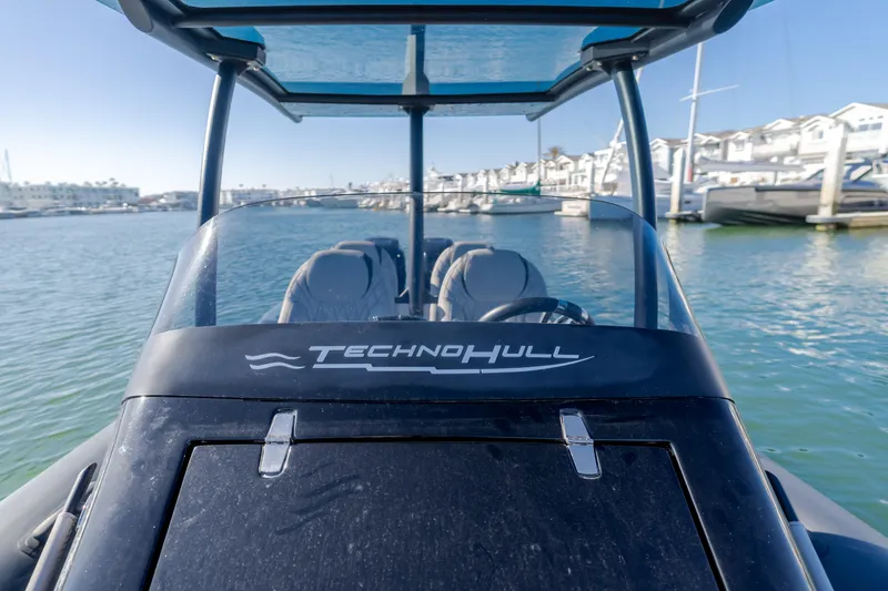 Slide: The Image of 2019 Technohull Sea DNA 999 boat docked in a marina, showcasing sleek design. - 25