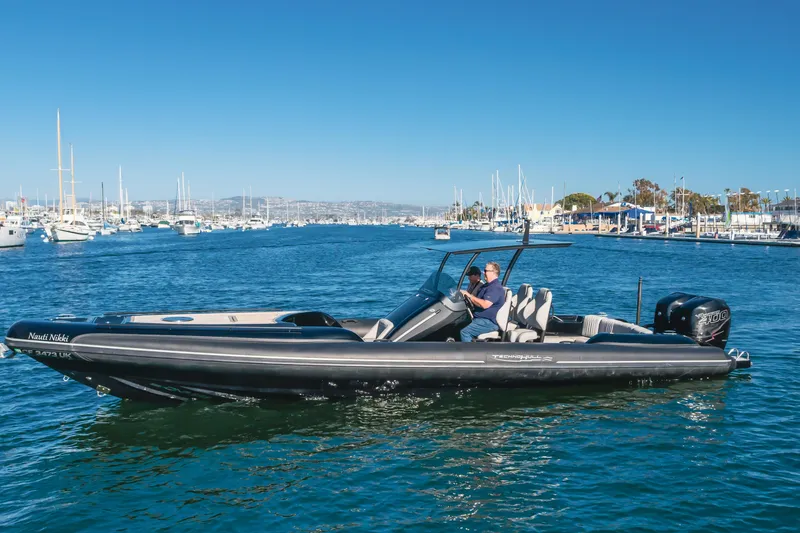 Slide: The Image of 2019 Technohull Sea DNA 999 boat cruising in a marina with clear blue skies. - 5
