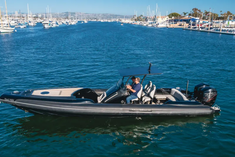 Slide: The Image of 2019 Technohull sea DNA 999 boat cruising in a marina with clear blue water. - 7
