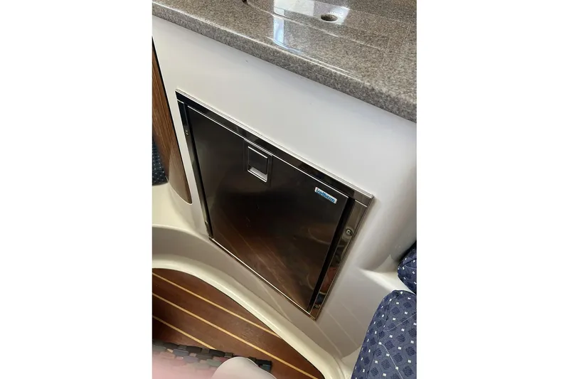 Slide: The Image of 2007 Pursuit OS 285 Offshore boat interior with compact refrigerator and countertop. - 15