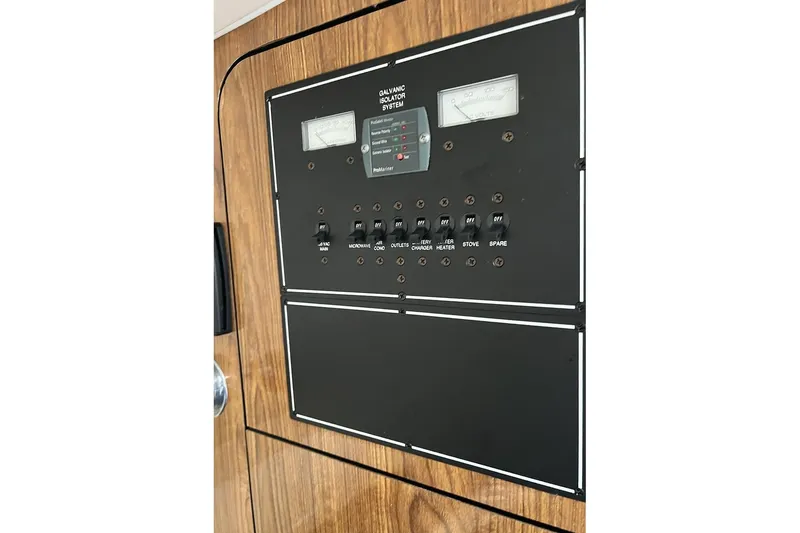 Slide: The Image of Electrical panel of a 2007 Pursuit OS 285 Offshore boat, featuring switches and gauges. - 17