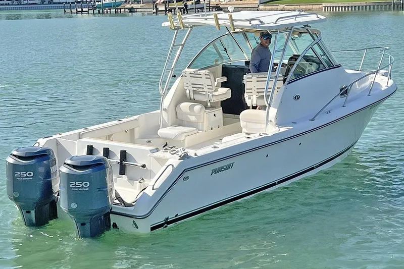 Slide: The Image of 2007 Pursuit OS 285 Offshore boat with dual 250 horsepower engines on clear water. - 2