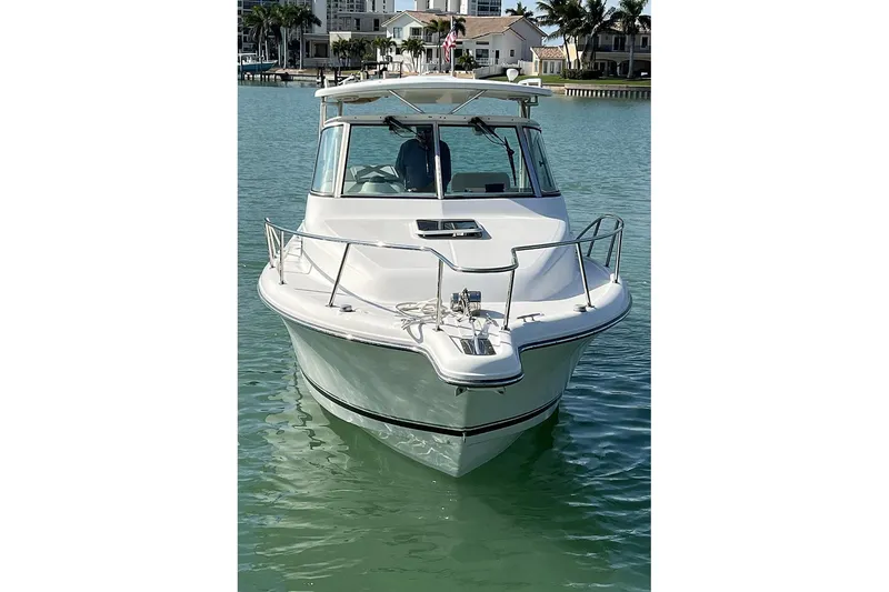 Slide: The Image of 2007 Pursuit OS 285 Offshore boat on calm water, front view. - 3