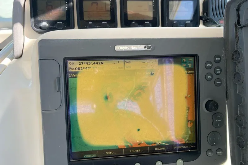Slide: The Image of 2007 Pursuit OS 285 Offshore boat dashboard with Raymarine navigation display. - 8