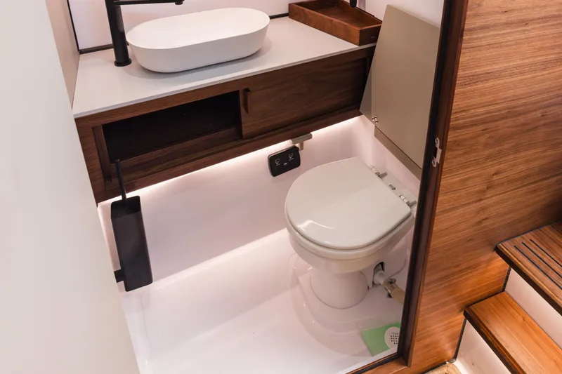 Slide: The Image of Modern bathroom in 2026 Axopar 38 Cross Cabin boat with sleek design and wood accents. - 11