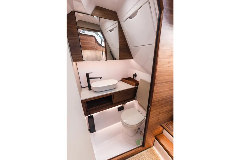 Slide: The Image of Luxurious bathroom interior of 2026 Axopar 38 Cross Cabin with modern fixtures and wood accents. - 13