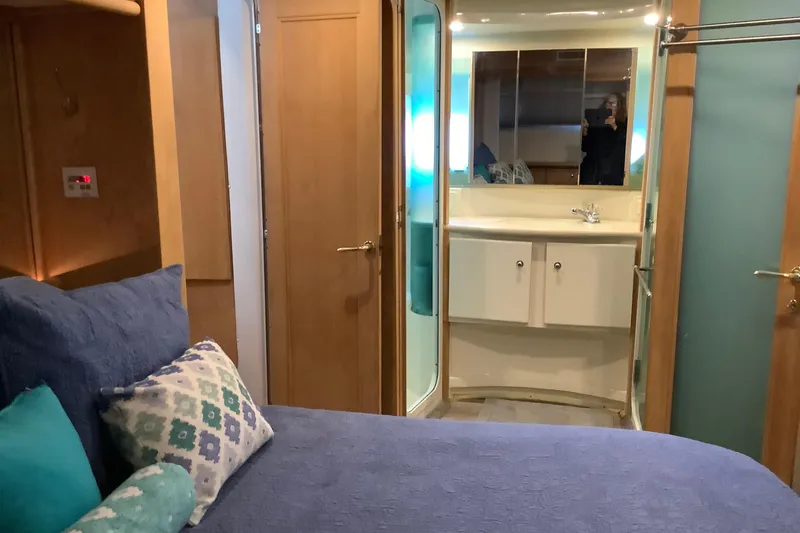 Slide: The Image of Interior of 1997 Carver 500 Cockpit Motor Yacht with cozy bedroom and ensuite bathroom. - 5