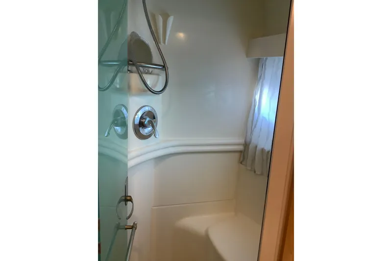 Slide: The Image of Shower area in 1997 Carver 500 Cockpit Motor Yacht, featuring modern fixtures and curtain. - 6