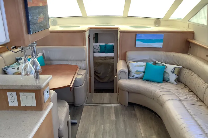 Slide: The Image of Interior of 1997 Carver 500 Cockpit Motor Yacht with cozy seating and dining area. - 7