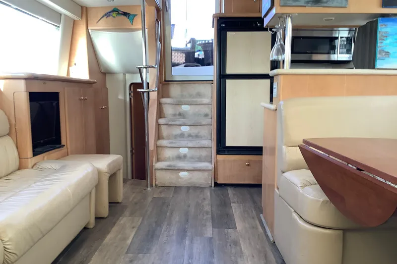 Slide: The Image of Kitchen area of a 1997 Carver 500 Cockpit Motor Yacht with wooden cabinets and appliances. - 8
