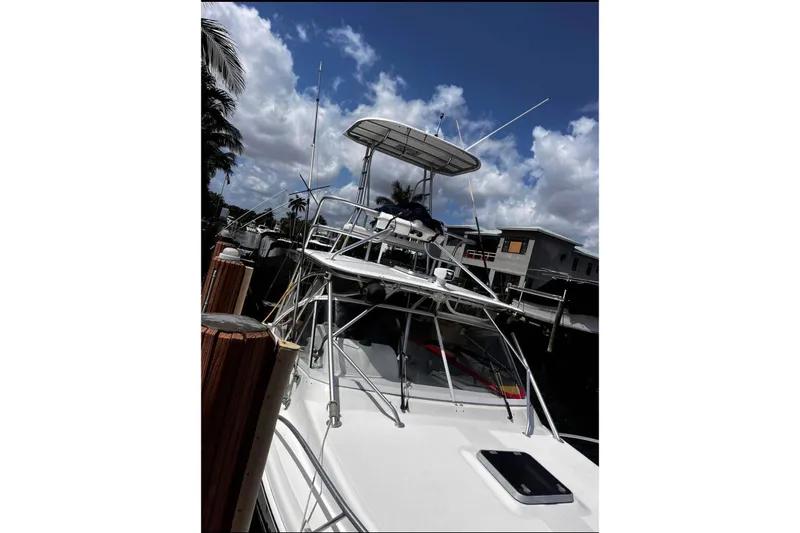 The Image of 2007 Lurhs Offshore Sport Fish boat docked under a partly cloudy sky. - 0