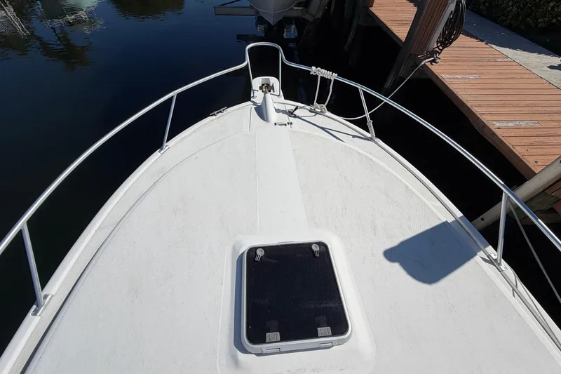 Slide: The Image of 2007 Luhrs 28 Open boat deck with railing and hatch, docked by wooden pier. - 16