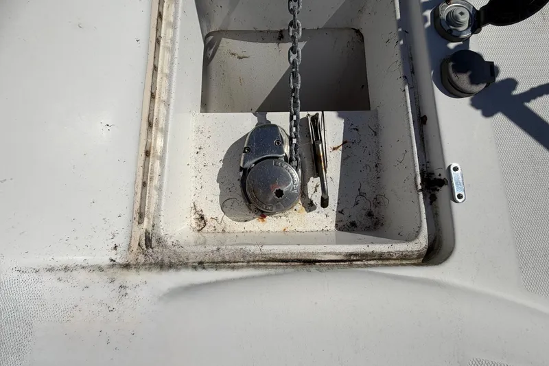 Slide: The Image of Anchor chain compartment on 2007 Luhrs 28 Open boat, showing winch and tools. - 20